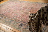 Distressed pink Sparta carpet field with faded palmettes and indigo blue motifs.