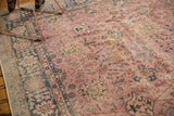 Distressed pink Sparta rug field with blue palmettes and muted coffee brown motifs.