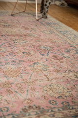Worn pink pile texture on the distressed Sparta rug, featuring palmettes and blue tendrils.