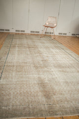 Distressed vintage Malayer carpet texture, showing worn knot heads, foundation, muted ivory, pale blue.