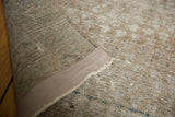 Vintage distressed Malayer carpet's worn pile, exposed foundation, and secured edge.
