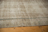 Distressed Malayer carpet, faded boteh patterns, visible foundation wear, aqua blue border.