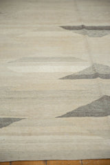 Hand-woven texture of a contemporary Kilim, featuring natural ivory and gray domed pyramid patterns.