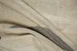 Contemporary Kilim carpet detail: undyed ivory, beige, gray wool texture with geometric lines.