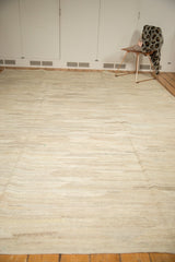 Allover abrashed striation designs on an Indian Kilim carpet in natural ivory, silver, and beige.