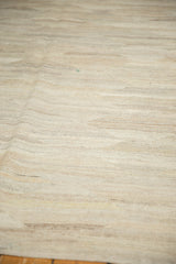 Hand woven Kilim texture with abrashed striations in natural ivory, silver, and beige.