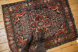 Vintage Dargezine square rug featuring quatrefoil medallion, red, navy Herati motif, with visible wear.