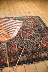Vintage Dargezine rug with nuanced Herati motif in madder red, navy, and visible tattered fringe.