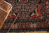 Nuanced madder root red border, Herati motif field, and tattered fringe on vintage Dargezine rug.