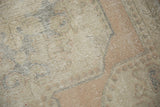 Distressed texture of vintage Oushak rug, showing worn beige, sand, and pale apricot pile.