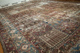 Distressed Bakhtiari carpet: paneled tree of life motifs, wine red, blue, exposed foundation.