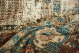 Distressed hand-knotted Bakhtiari carpet pile with visible foundation and muted blue, bronze tones.