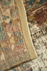 Distressed Bakhtiari carpet detail, revealing worn pile, visible foundation, and secured edge.