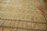 Distressed Oushak carpet detail, faded gold field, ocean blue green floral bouquets, brown border.