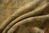 Soft, worn pile of a distressed Oushak rug with faded saffron and ocean blue-green florals.