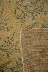 Vintage distressed Oushak rug corner, showing hand-knotted back and restored side selvage.