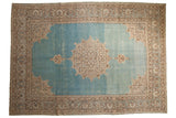 Distressed vintage Tabriz rug featuring an ivory roundel medallion on a watery, abrashed aqua blue field.