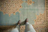 Evenly worn, low pile texture on the watery blue field of a distressed vintage Tabriz carpet.