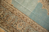 Even wear across the knot heads of a vintage Tabriz showing its abrashed aqua field and floral border.