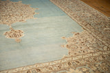 Trefoil medallion edge and floral border on a watery blue, distressed vintage Tabriz carpet.