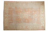 Pale peach and ivory distressed Oushak carpet with an elongated center medallion, 8'2