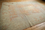 Textural view of a vintage Oushak carpet, highlighting faded pale peach and ivory tones.