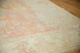 Worn texture and exposed foundation of a distressed vintage Oushak rug, pale peach and ivory.