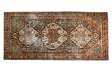 Distressed Vintage Bakhtiari runner rug with triple medallions and vivid Afshari motifs in mixed tones.