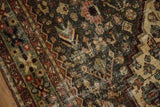 Distressed pile texture of a vintage Bakhtiari runner with intricate teal and terracotta motifs.