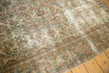 Distressed Mahal rug fragment with visible foundation, featuring muted green and terracotta Herati motif.