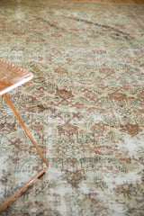 Distressed Mahal carpet's worn Herati motif, foundation exposed, with ivory, terracotta, silver hues.