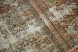 Distressed vintage Mahal rug texture showing exposed ivory foundation and faded terracotta motifs.