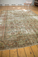Bottom edge view of distressed Mahal carpet fragment with terracotta border and ivory Herati design.