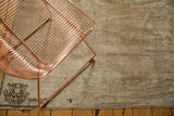 Distressed vintage Oushak carpet corner, showing antique ivory and chocolate brown pattern.