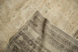 Textured antique ivory pile of a distressed Oushak rug revealing its hand knotted foundation.