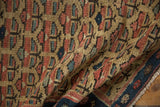 Time-softened antique Caucasian runner, red, blue, saffron plant motif, navy border.