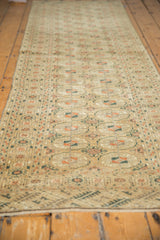 Distressed Vintage Turkmen runner's soft pile, floral gul motifs in sand, terra cotta, with intact selvage.