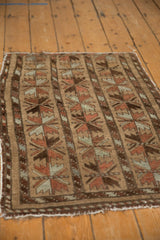 Belouch rug with triple column floral cross sections in camel, red, and silver.