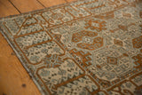 Distressed Belouch rug border showcasing germinating trees and lattice motifs in bronze, ivory, silver.