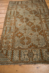 Distressed pile texture and secure fringe of the vintage Belouch rug.