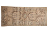 Distressed Serab runner featuring geometric stepped medallions, abrash in muted ivory, powder blue. 3'1