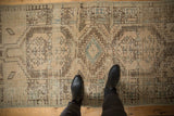Distressed Serab runner underfoot, showcasing geometric medallions, muted ivory and blue.