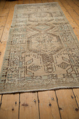 Distressed vintage Serab runner texture, showing abrash, wear, ivory and seafoam geometric motifs.