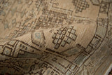 Textured pile of a distressed Serab runner with stepped geometric motifs, ivory, seafoam, and visible wear.