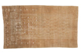Distressed vintage Belouch rug, softly worn beige and ivory tones featuring a prayer motif.