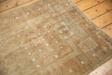 Neutral toned distressed Belouch rug showing subtle white motifs and even pile wear to foundation.
