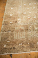 Distressed pile of vintage Belouch rug, showing even wear and subtle boteh motifs.