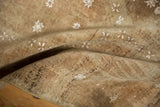 Distressed Belouch rug pile with even wear, faint foundation, and white boteh motifs.