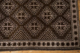 Distressed Oushak rug corner detail, chocolate brown geometric medallions, starburst border, even wear.