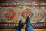 Vintage Serab runner showcasing geometric double medallions, madder red, ivory, blue, and mostly even wear.